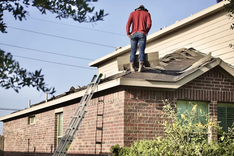 Professional roofer working on a residential roof in Muleshoe